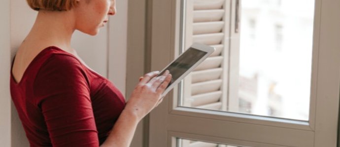 homeowner browsing window treatment options on tablet