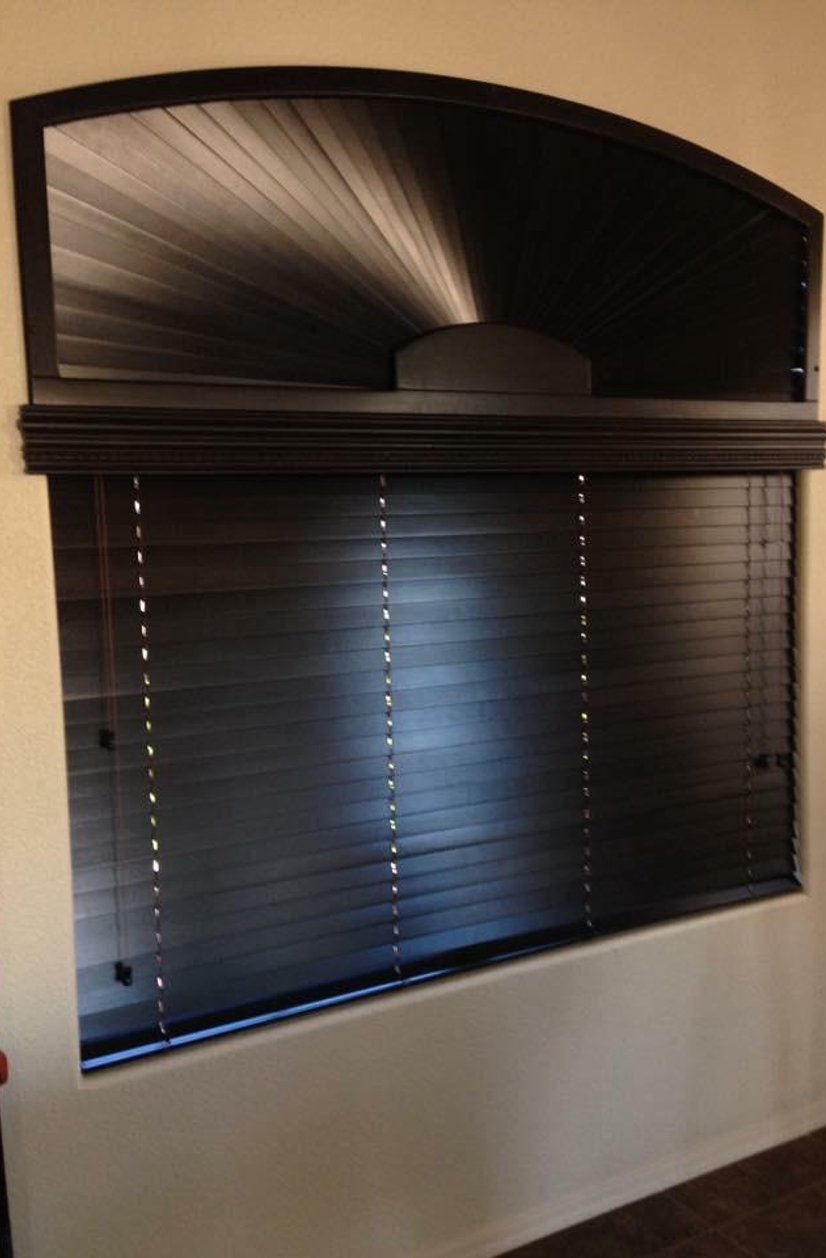 dark wood blinds with an arched sunburst window topper in a game room