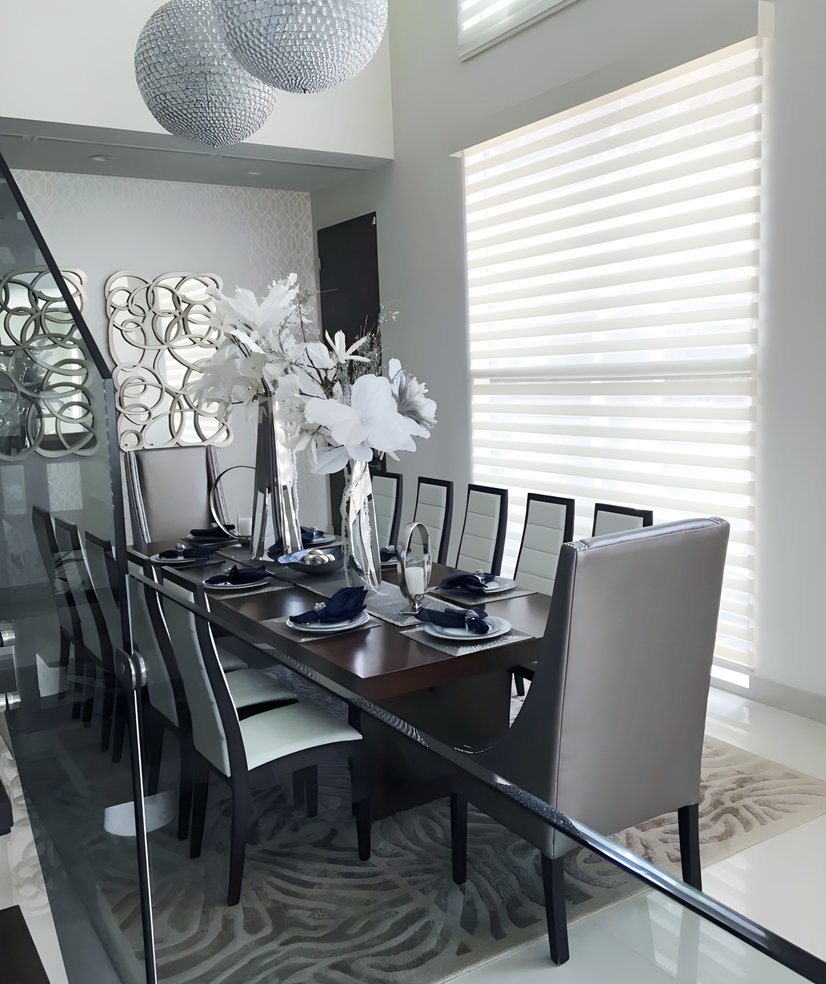 dual sheer shades in a modern dining room with crystal chandeliers