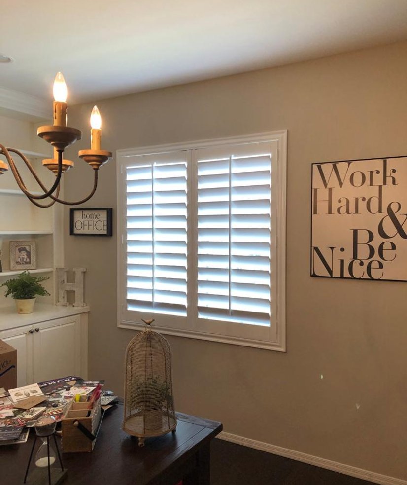 white plantation shutters in a home office